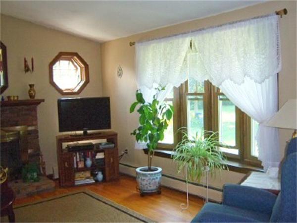 15 Squareshire Road Sterling, MA 01564 - Photo 11 of 30 a living room with furniture a potted plant and a fireplace