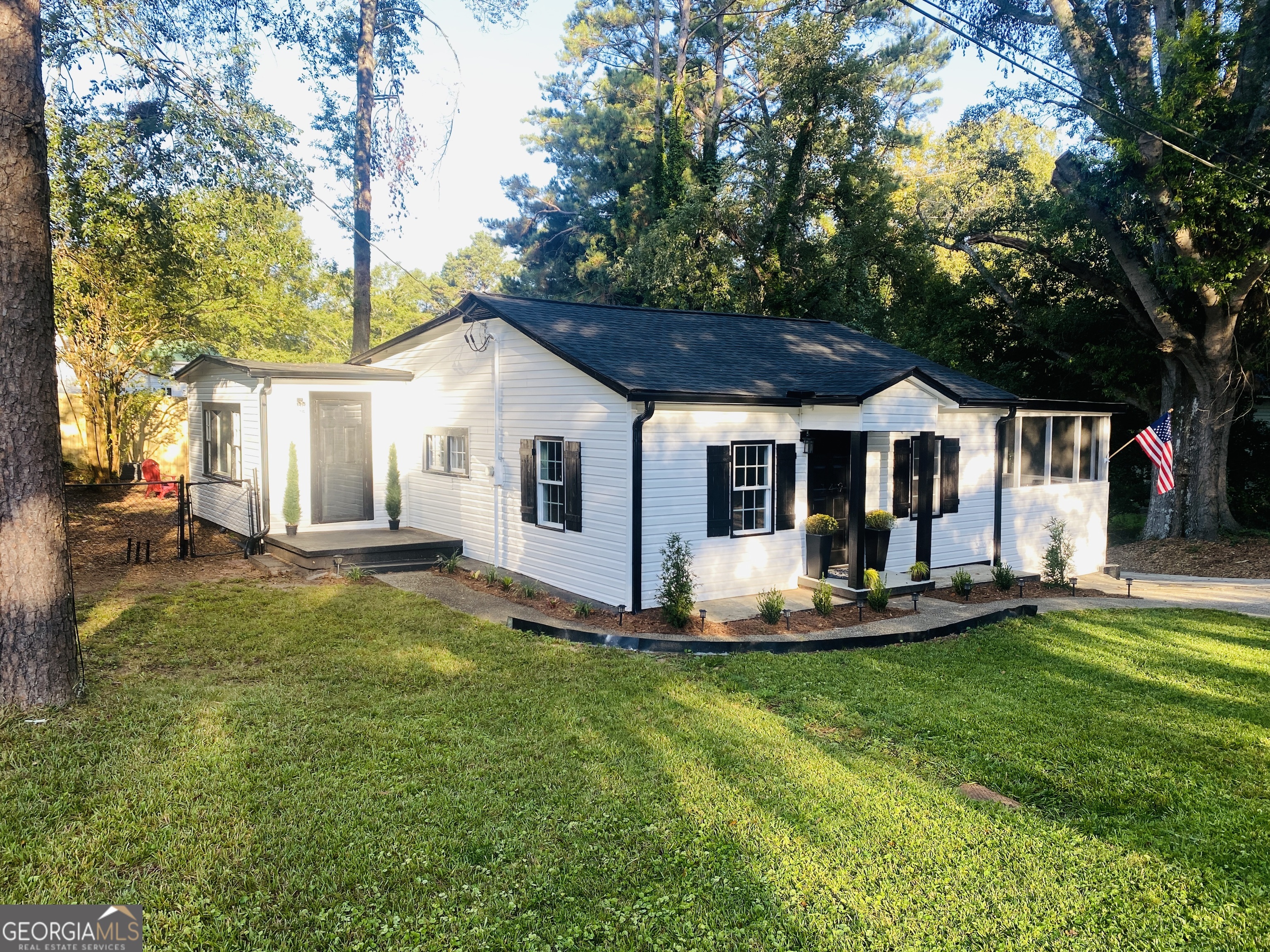 a front view of a house with a yard porch and seating area