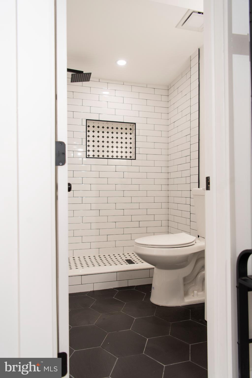 3309 22nd Street Northeast Washington, DC 20018 - Photo 11 of 36 a bathroom with a toilet and a shower