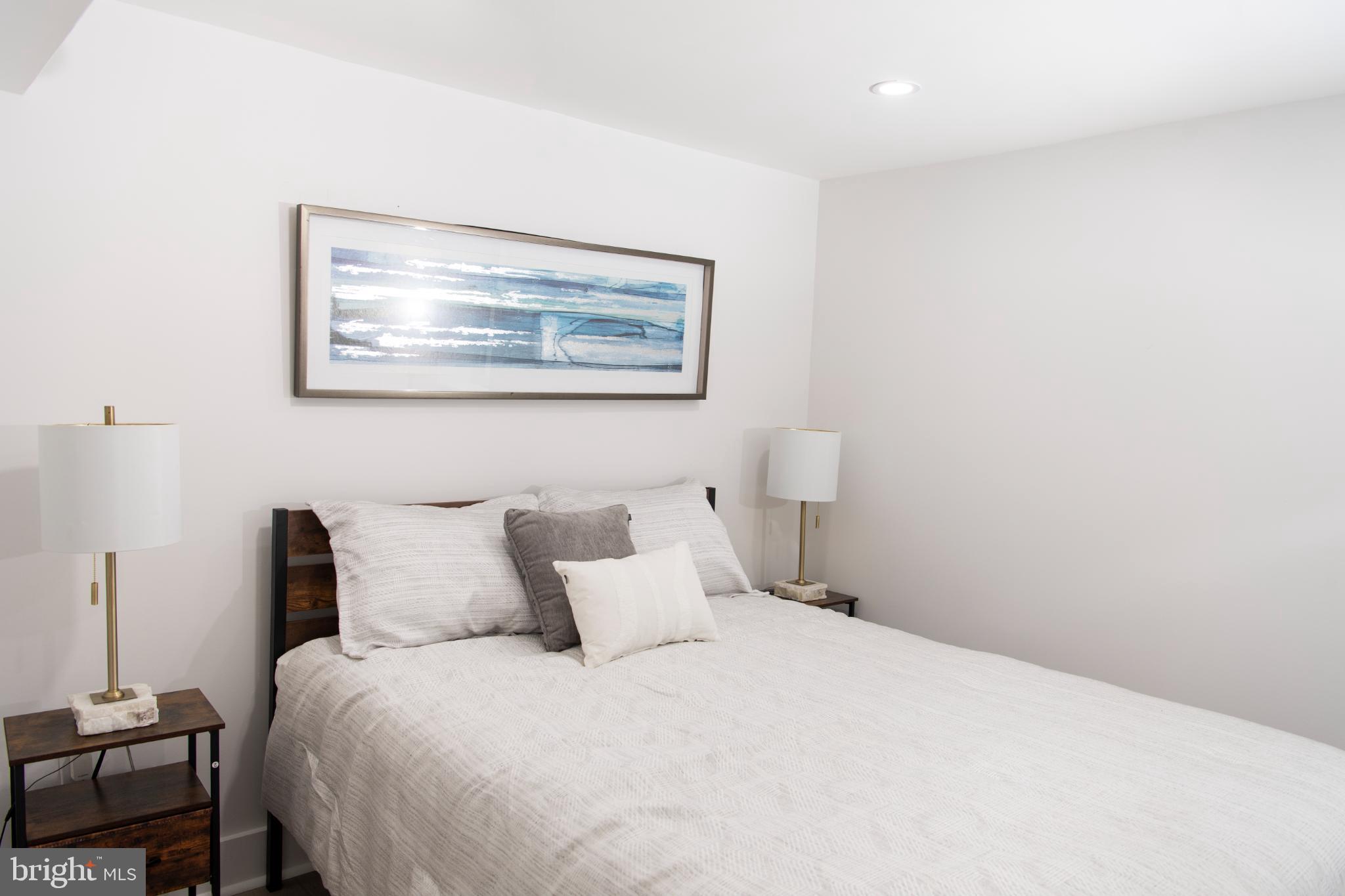 3309 22nd Street Northeast Washington, DC 20018 - Photo 13 of 36 a bedroom with a bed and painting on the wall
