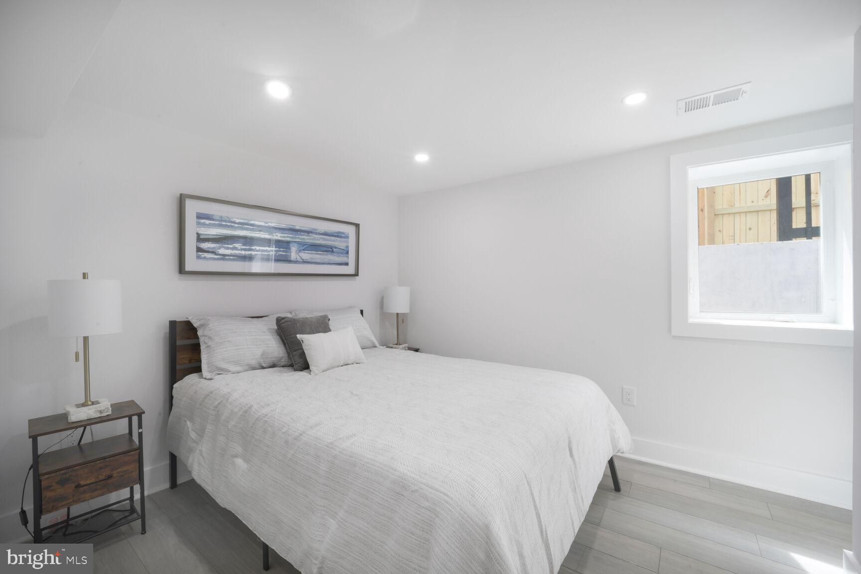 3309 22nd Street Northeast Washington, DC 20018 - Photo 26 of 36 a bedroom with a large bed and a window