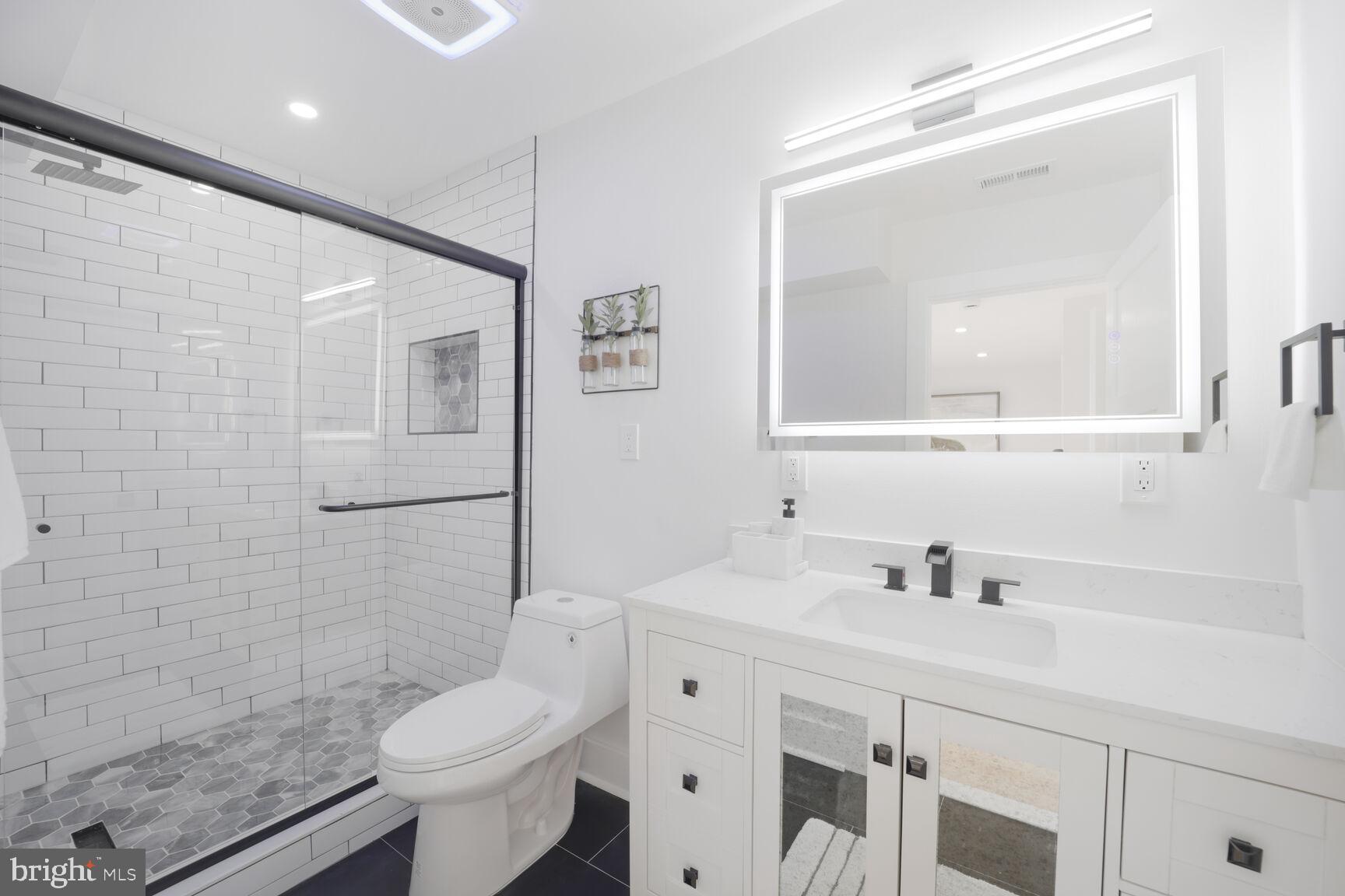 3309 22nd Street Northeast Washington, DC 20018 - Photo 27 of 36 a bathroom with a sink toilet and mirror