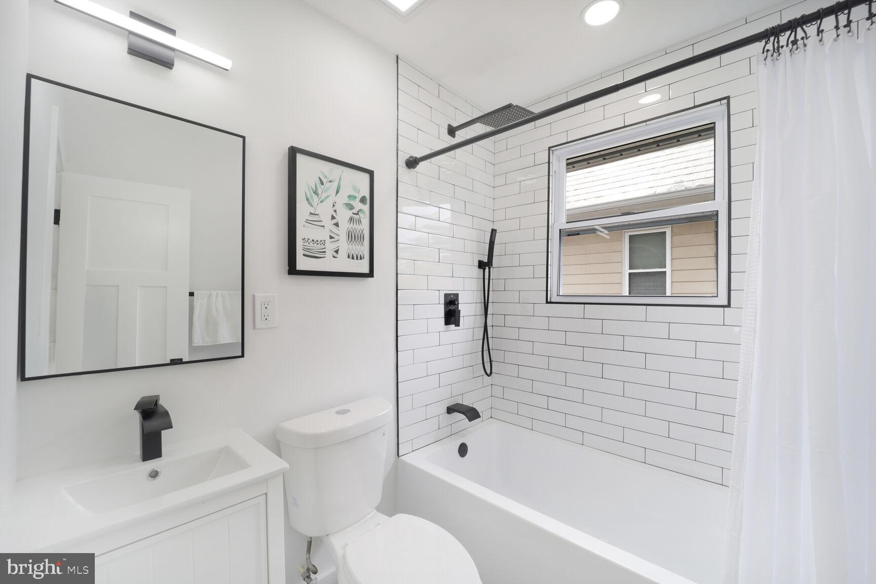 3309 22nd Street Northeast Washington, DC 20018 - Photo 28 of 36 a bathroom with a bathtub shower sink vanity and toilet