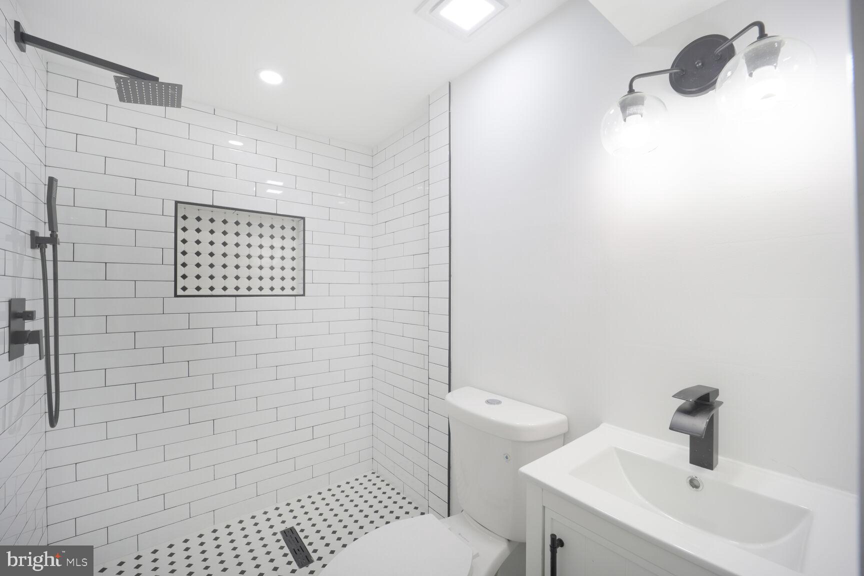 3309 22nd Street Northeast Washington, DC 20018 - Photo 29 of 36 a bathroom with a toilet and a sink