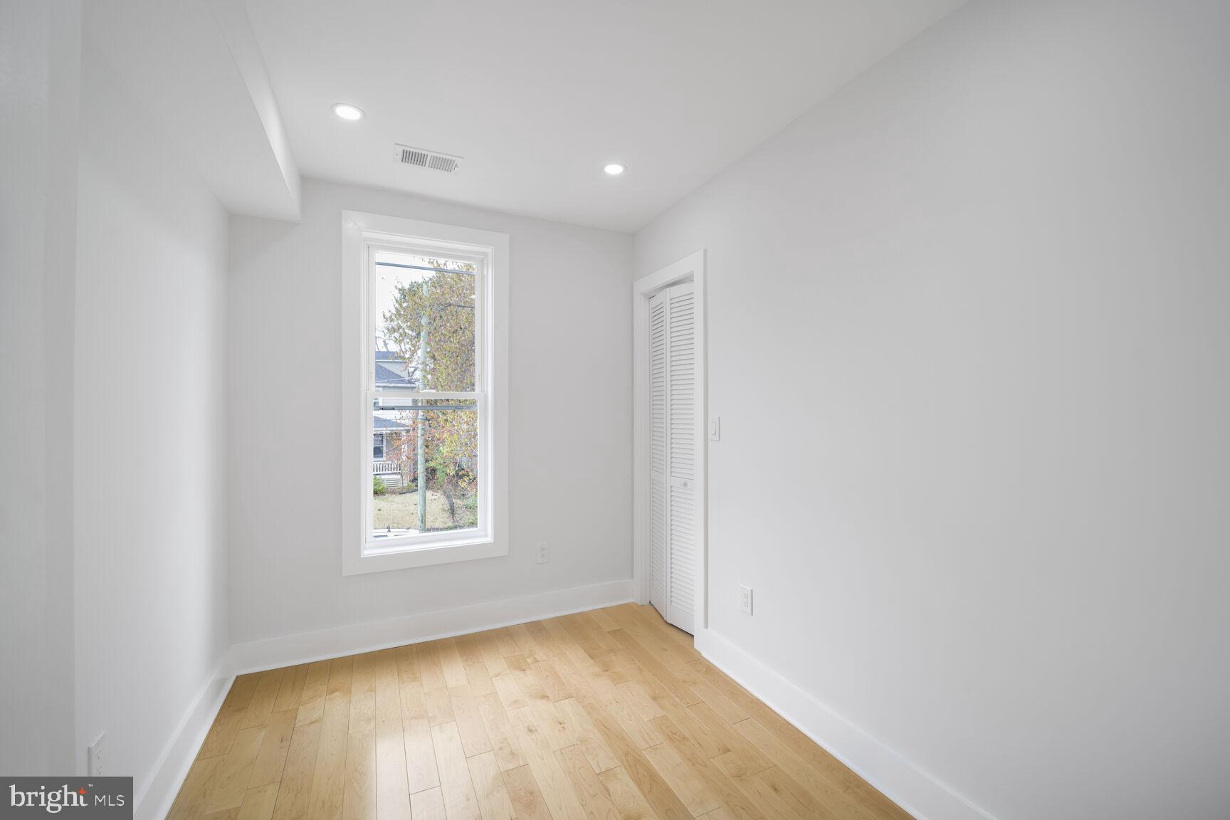 3309 22nd Street Northeast Washington, DC 20018 - Photo 31 of 36 an empty room with wooden floor and windows