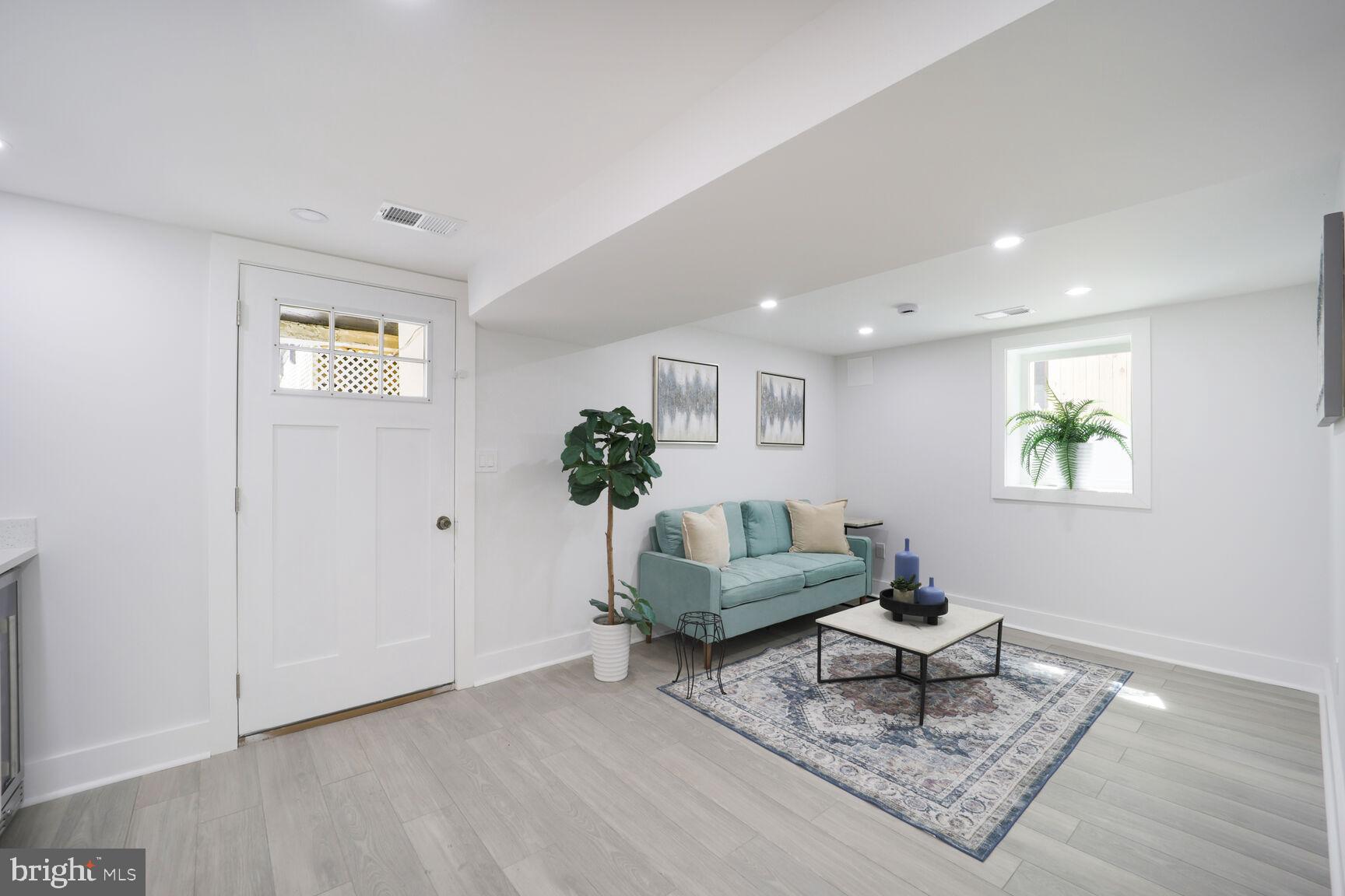 3309 22nd Street Northeast Washington, DC 20018 - Photo 32 of 36 a living room with furniture and a potted plant