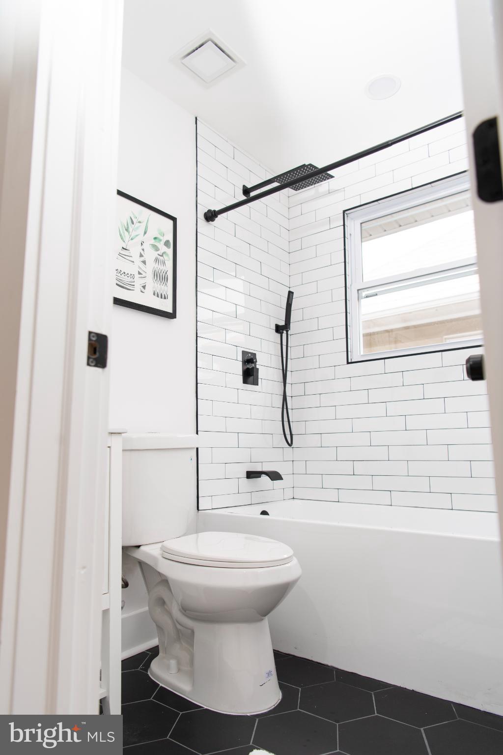 3309 22nd Street Northeast Washington, DC 20018 - Photo 9 of 36 a bathroom with a toilet sink and a shower