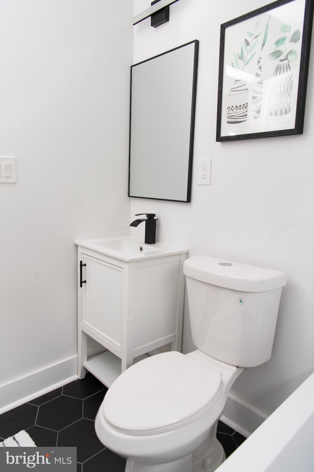 3309 22nd Street Northeast Washington, DC 20018 - Photo 10 of 36 a white toilet sitting next to a bathroom sink