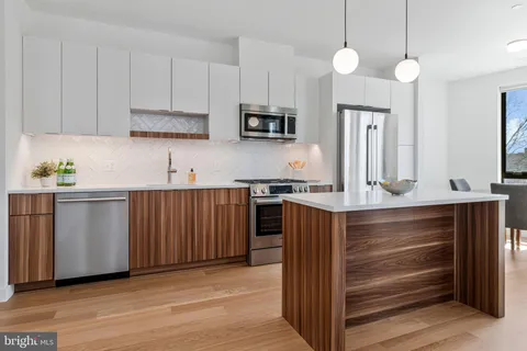 a kitchen with wooden cabinets and white appliances