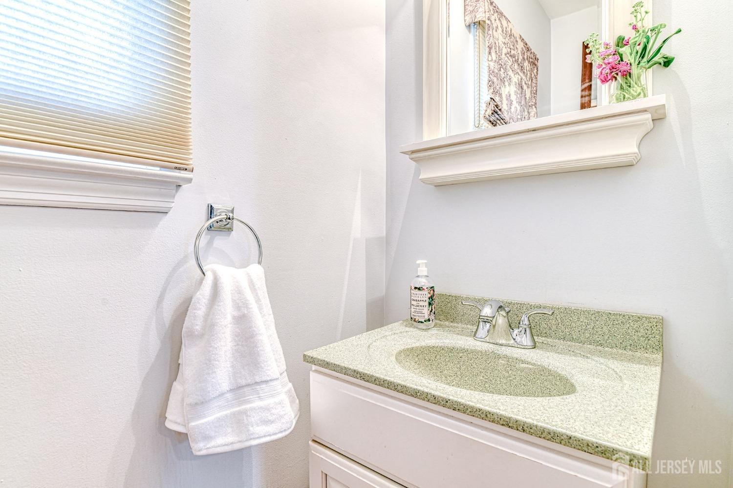 10 Graulich Drive Milltown, NJ 08850 - Photo 19 of 40 a bathroom with a sink and a mirror