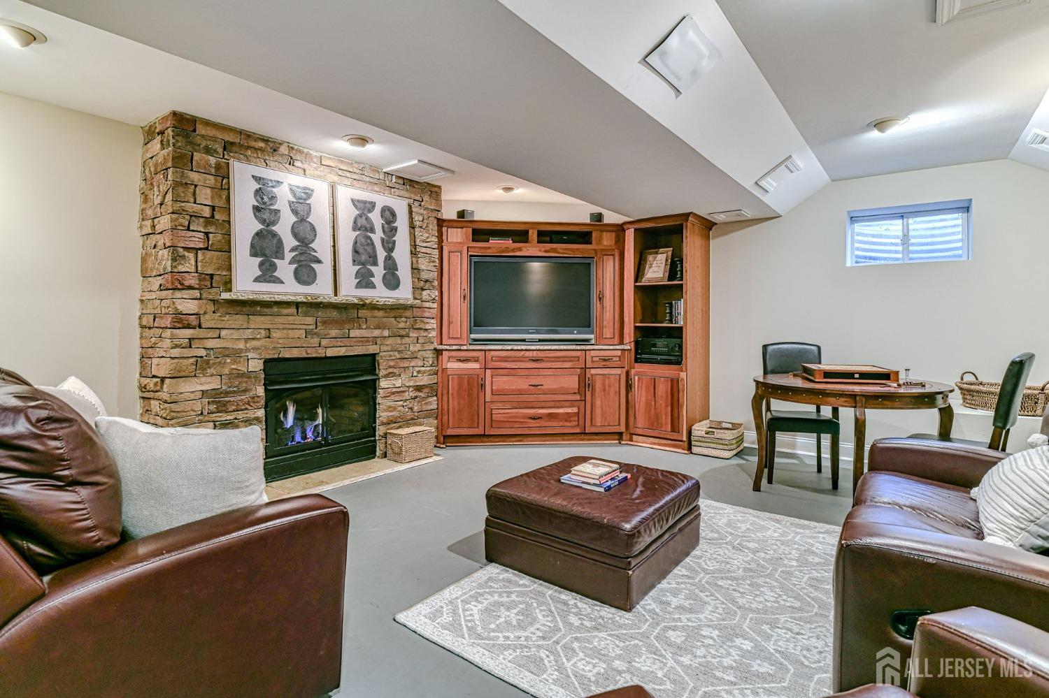 10 Graulich Drive Milltown, NJ 08850 - Photo 20 of 40 a living room with furniture a flat screen tv and a fireplace