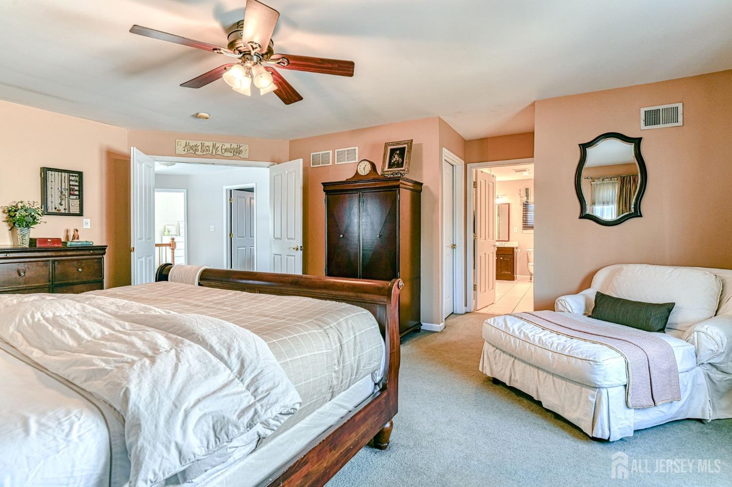 10 Graulich Drive Milltown, NJ 08850 - Photo 28 of 40 a bedroom with a bed and a chandelier