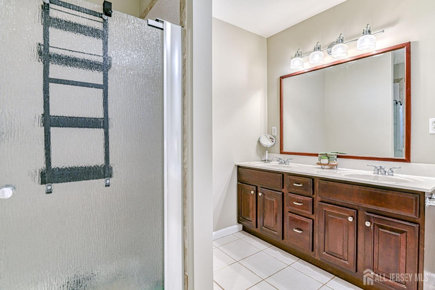 10 Graulich Drive Milltown, NJ 08850 - Photo 30 of 40 a bathroom with a double vanity sink and mirror