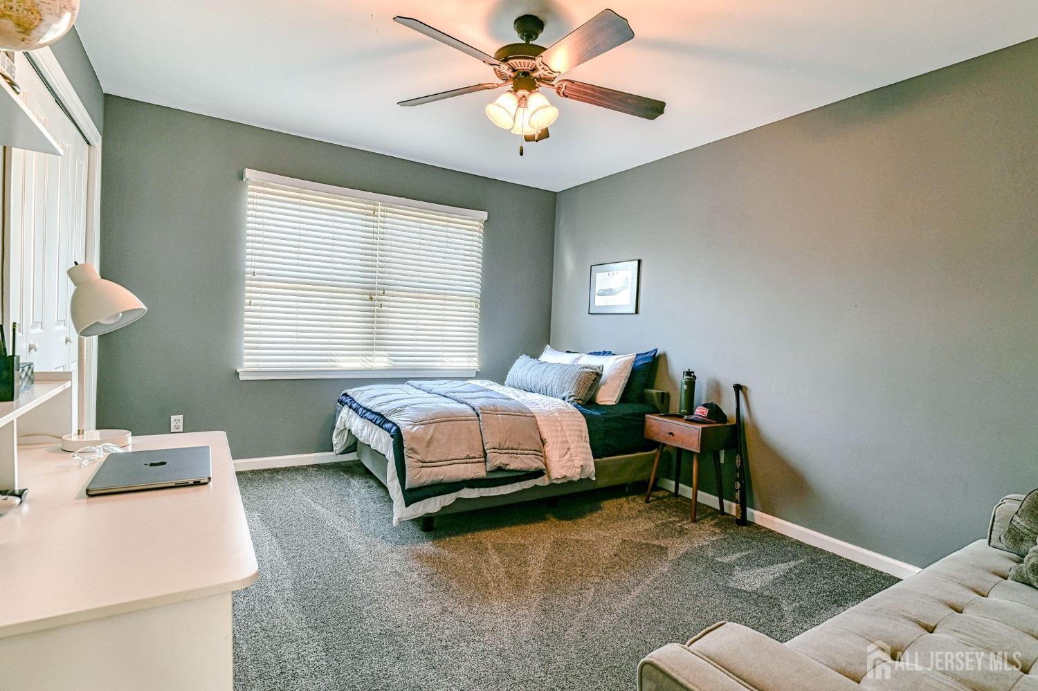 10 Graulich Drive Milltown, NJ 08850 - Photo 31 of 40 a bedroom with a bed and a chandelier