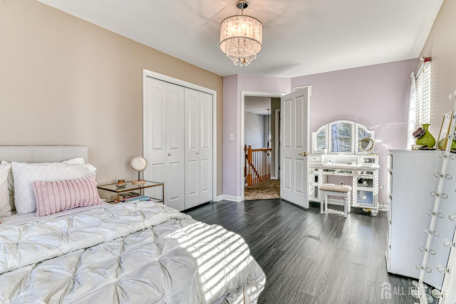 10 Graulich Drive Milltown, NJ 08850 - Photo 32 of 40 a bedroom with a bed and wooden floor