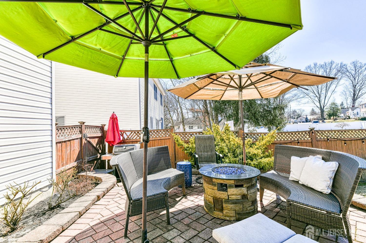 10 Graulich Drive Milltown, NJ 08850 - Photo 36 of 40 a view of a patio with a dining table and chairs under an umbrella