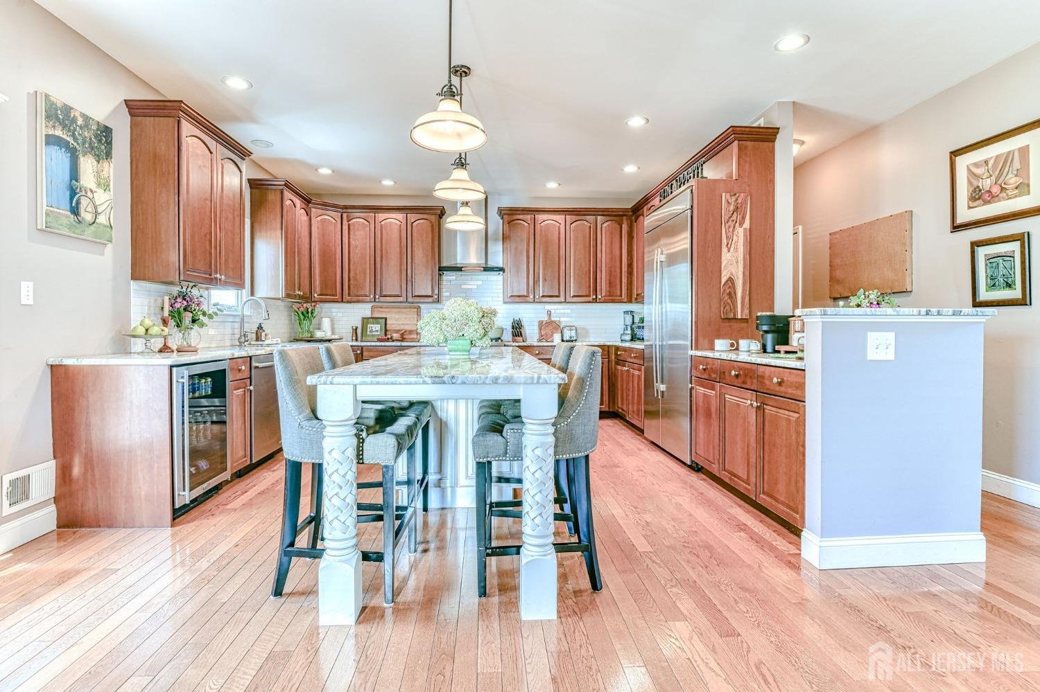 10 Graulich Drive Milltown, NJ 08850 - Photo 5 of 40 a open dining room with stainless steel appliances kitchen island granite countertop wooden floor a dining table and chairs