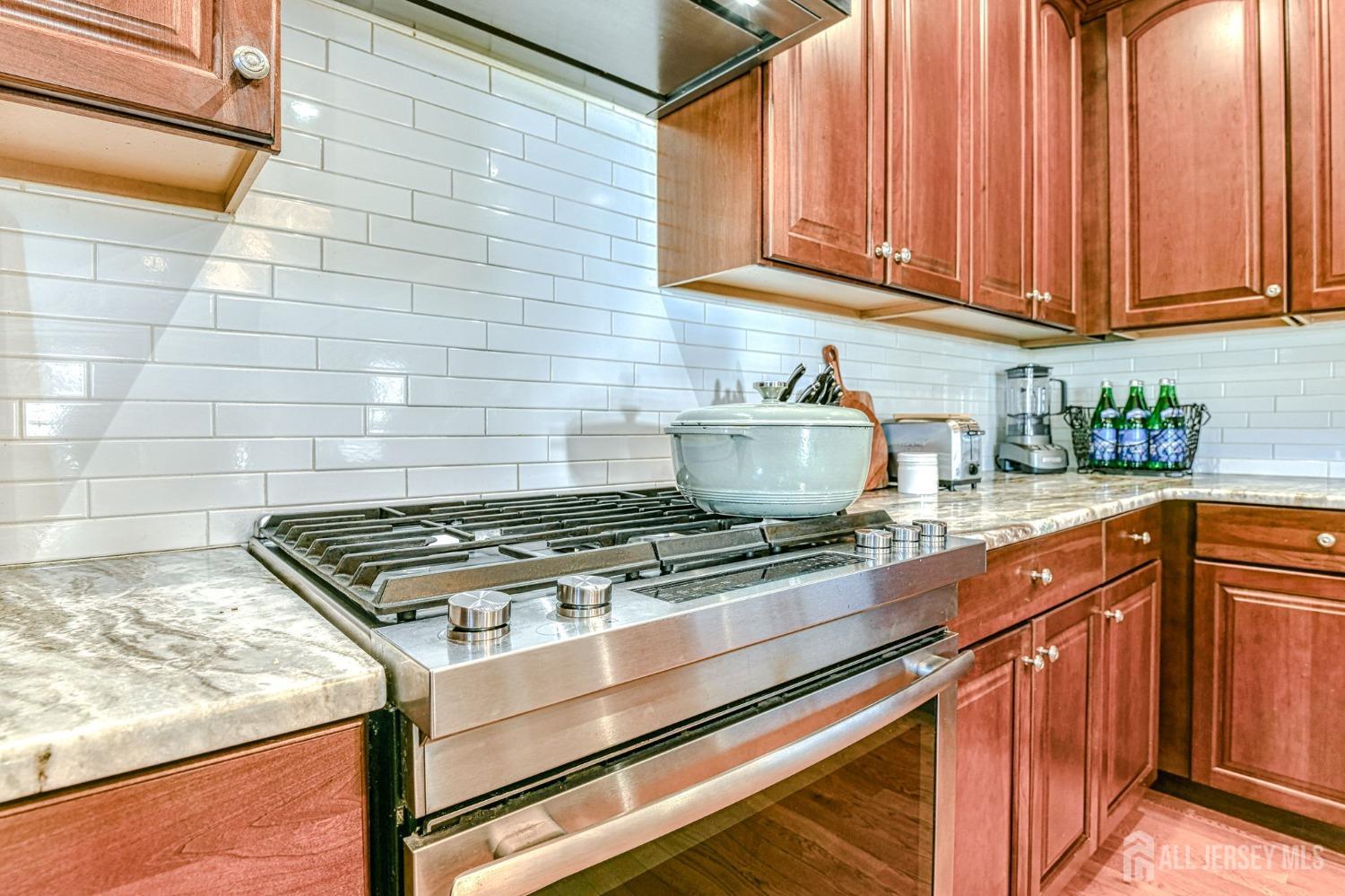 10 Graulich Drive Milltown, NJ 08850 - Photo 7 of 40 a kitchen with granite countertop a stove sink and cabinets
