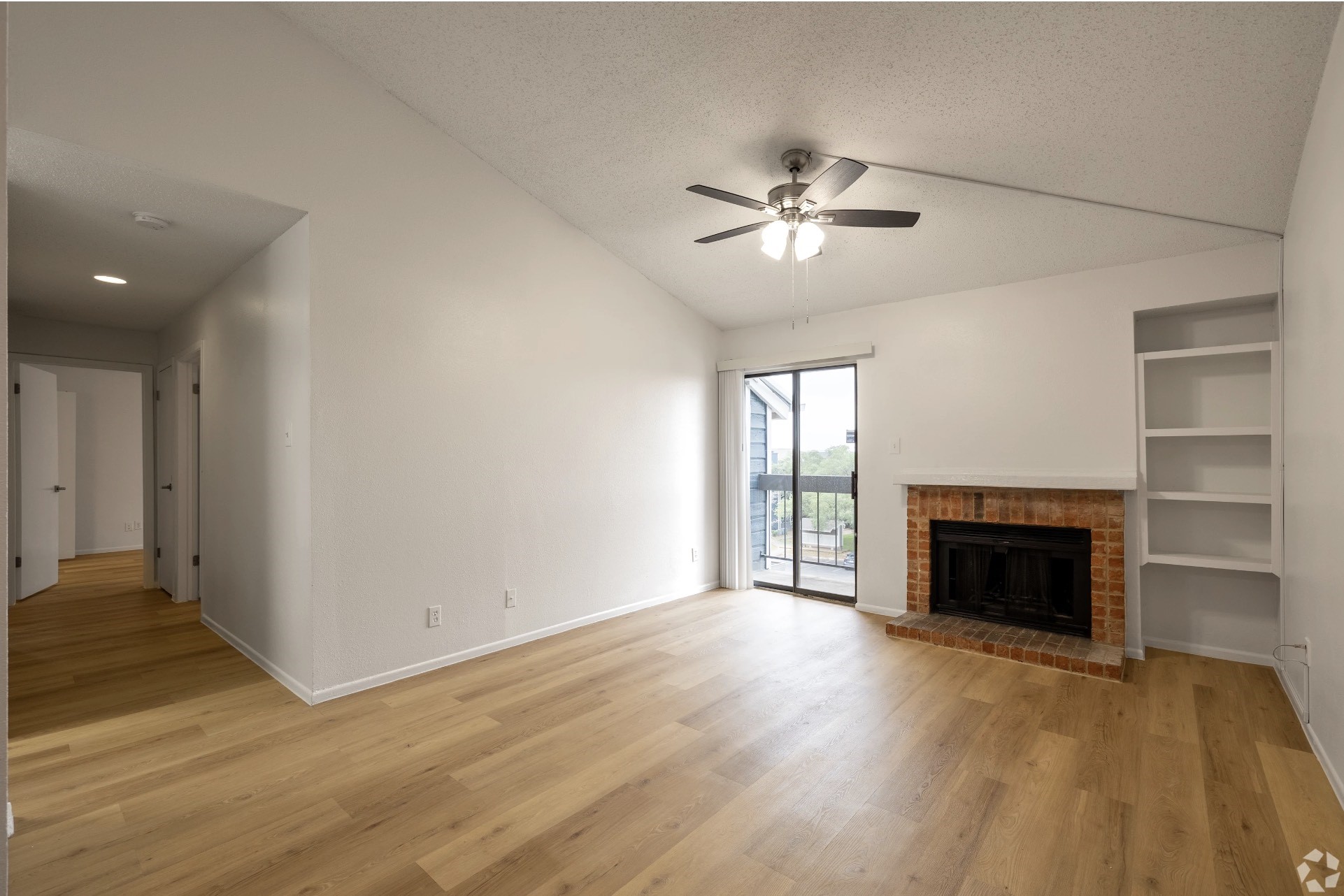 2170 Thousand Oaks Drive, Unit 814T San Antonio, TX 78232 - Photo 24 of 36 wooden floor fireplace and windows in an empty room