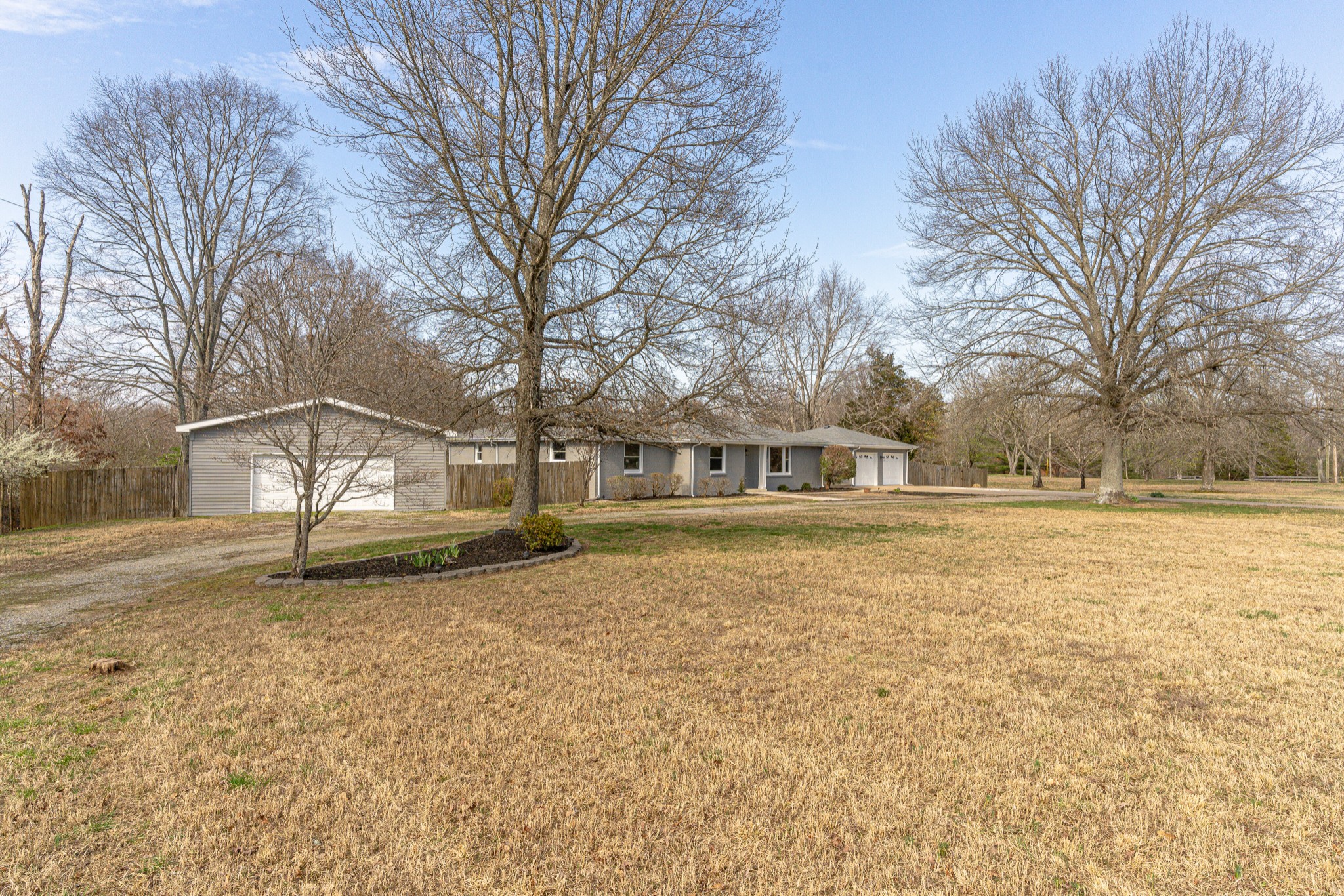 7302 Henry Road Fairview, TN 37062 - Photo 2 of 69 a white house that has a tree in front of it
