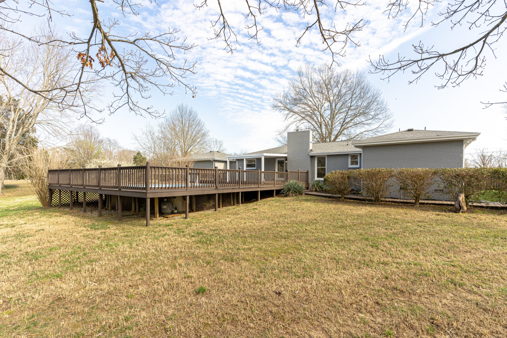 7302 Henry Road Fairview, TN 37062 - Photo 40 of 69 a backyard of a house with large trees and deck
