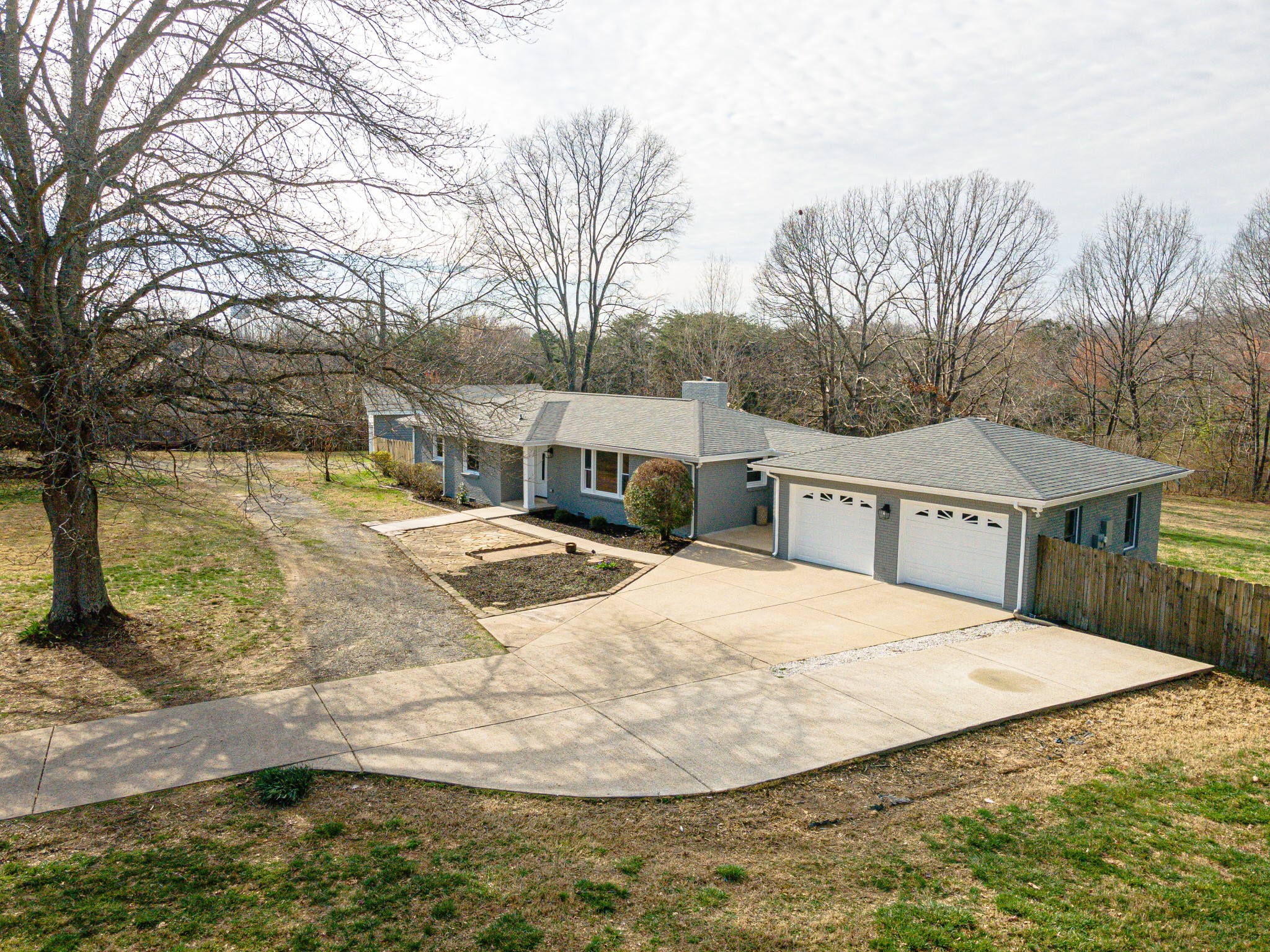 7302 Henry Road Fairview, TN 37062 - Photo 44 of 69 a view of a house with a yard covered in snow