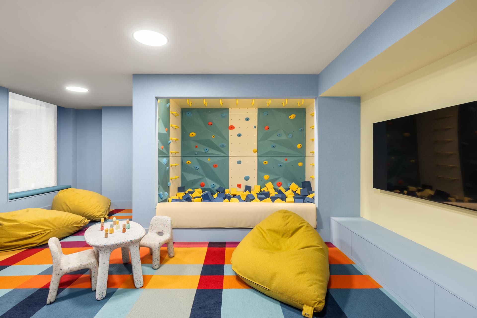 85 Worth Street, Unit 5 Manhattan, NY 10013 - Photo 16 of 20 a living room with furniture and a flat screen tv