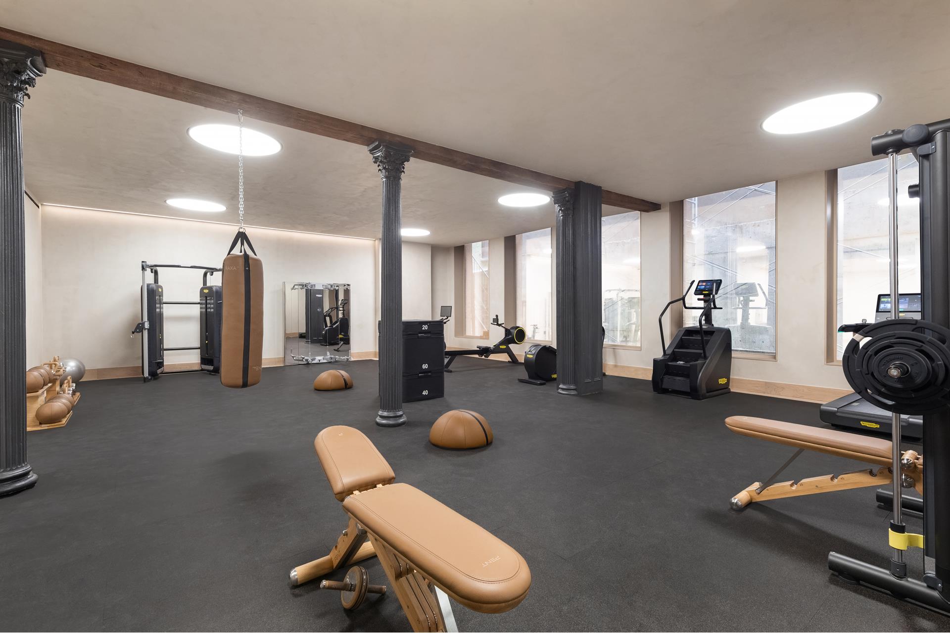 85 Worth Street, Unit 5 Manhattan, NY 10013 - Photo 9 of 20 a room with gym equipment and a large window