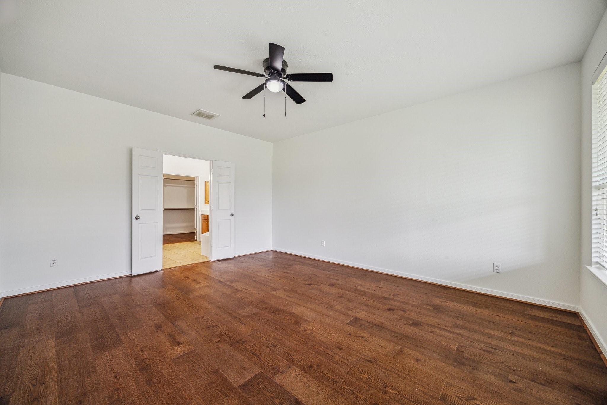 26402 Larkspur Ridge Drive Katy, TX 77494 - Photo 16 of 34 a view of empty room with wooden floor and windows