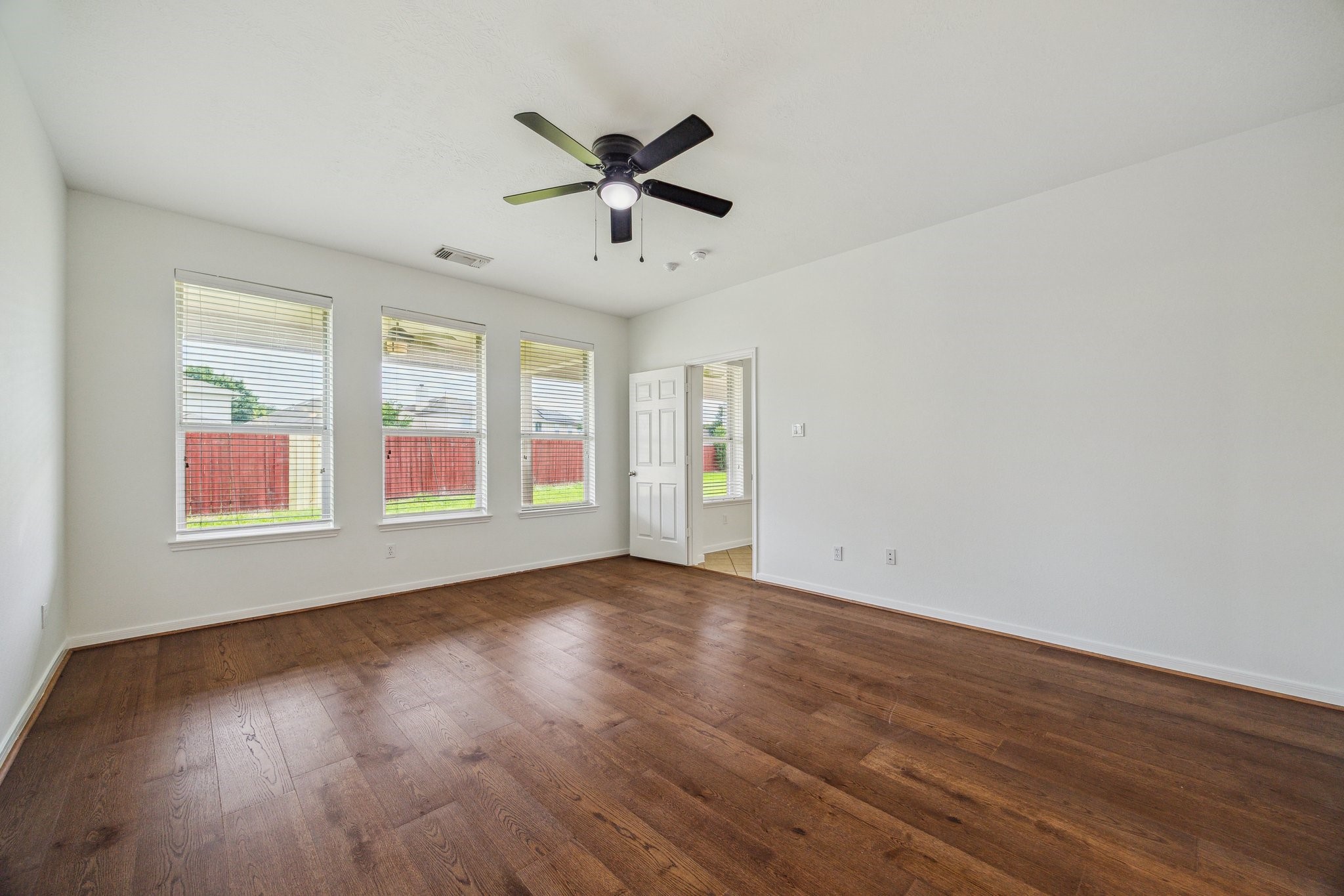 26402 Larkspur Ridge Drive Katy, TX 77494 - Photo 17 of 34 a view of an empty room with wooden floor and a window