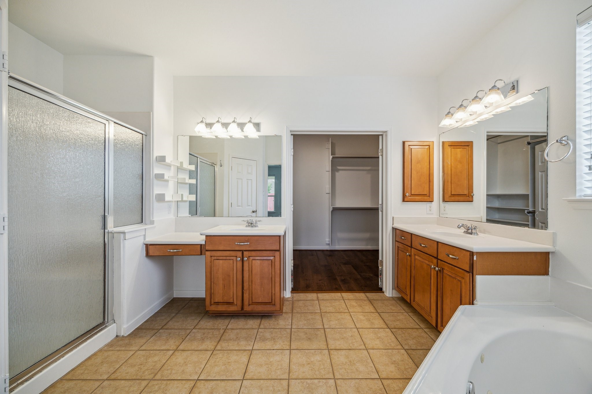 26402 Larkspur Ridge Drive Katy, TX 77494 - Photo 18 of 34 a large bathroom with a large mirror vanity and shower