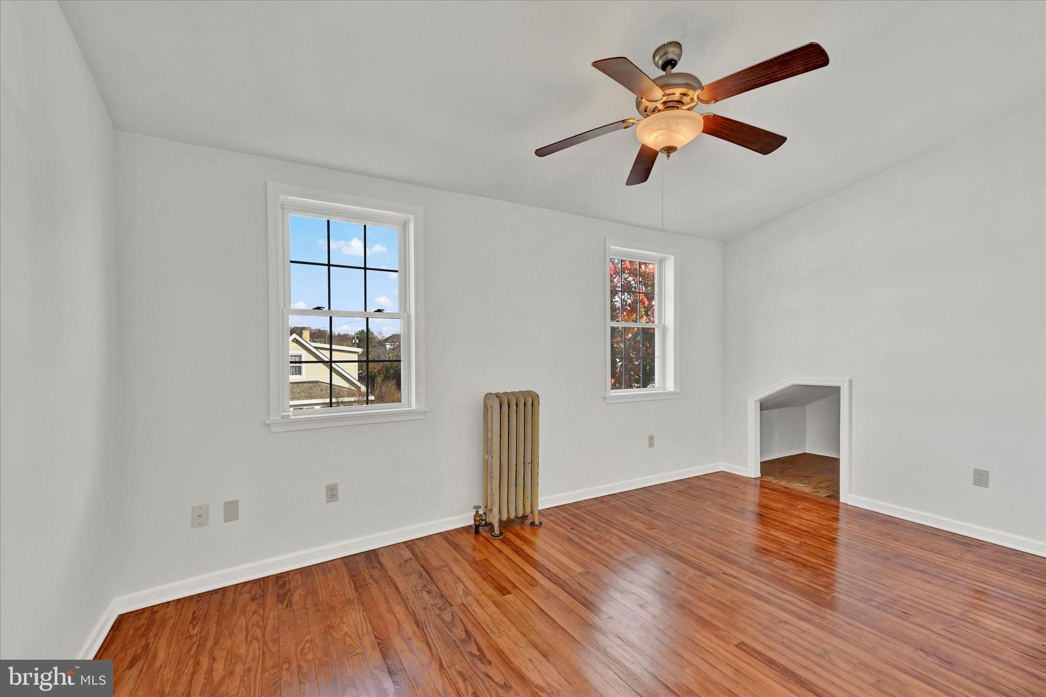 1203 Fairfield Avenue Baltimore, MD 21209 - Photo 18 of 32 wooden floor in an empty room with a window