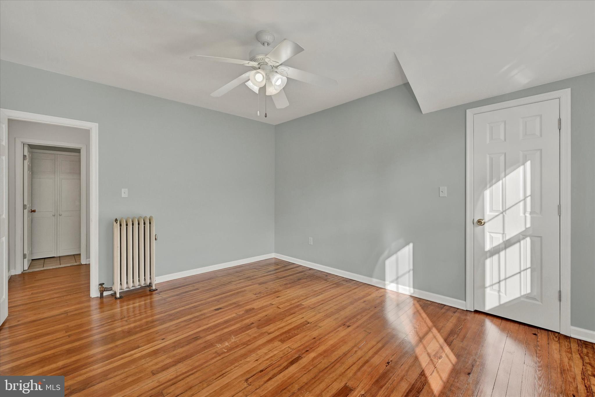 1203 Fairfield Avenue Baltimore, MD 21209 - Photo 19 of 32 a view of an empty room with wooden floor and a window