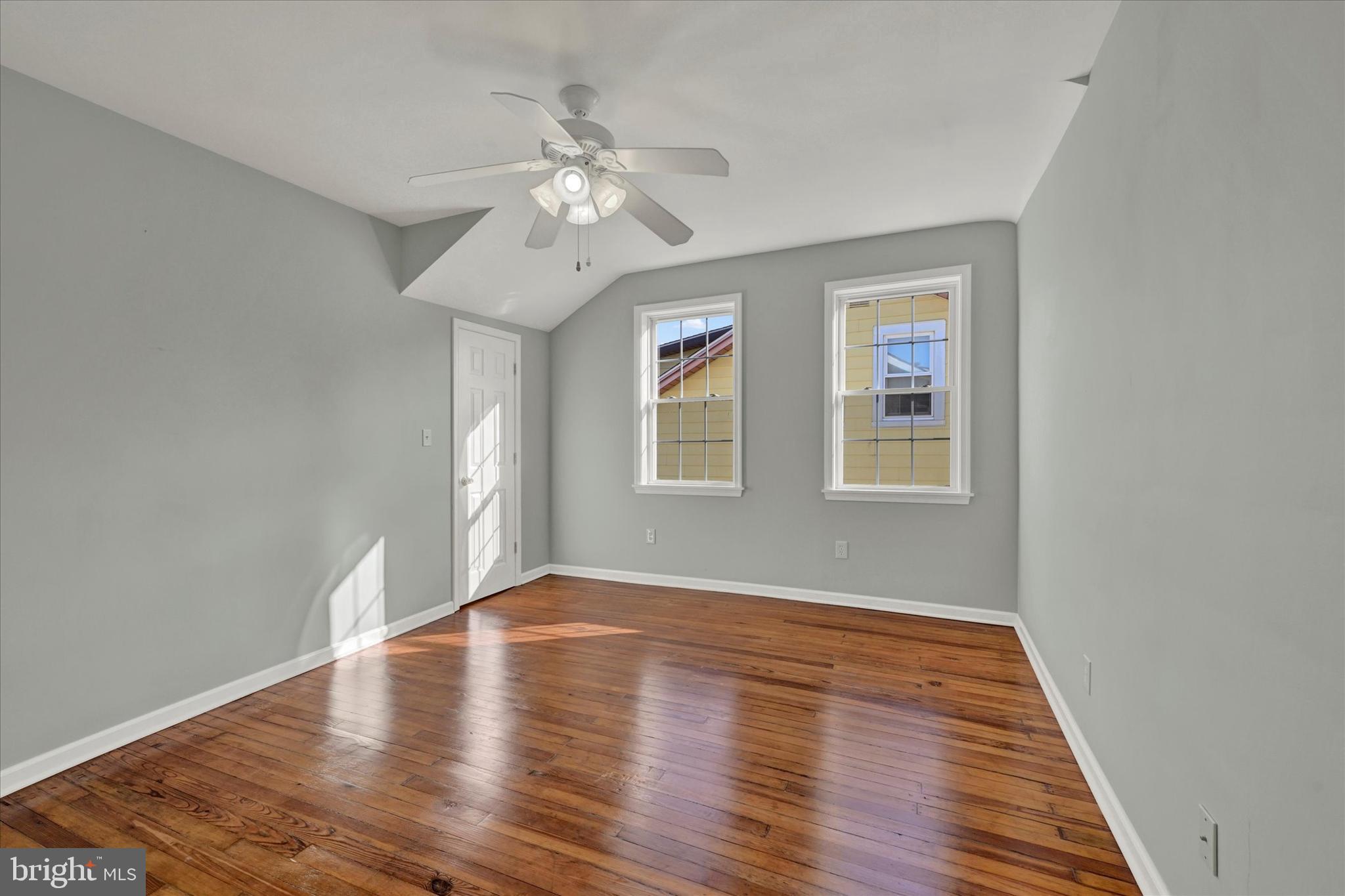 1203 Fairfield Avenue Baltimore, MD 21209 - Photo 20 of 32 a view of an empty room with wooden floor and window