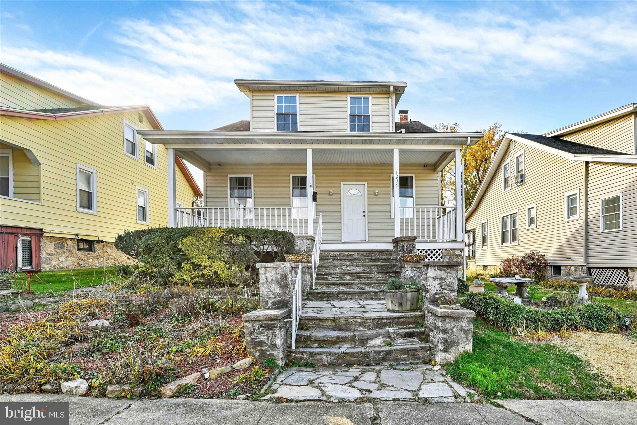1203 Fairfield Avenue Baltimore, MD 21209 - Photo 2 of 32 a front view of a house with a yard