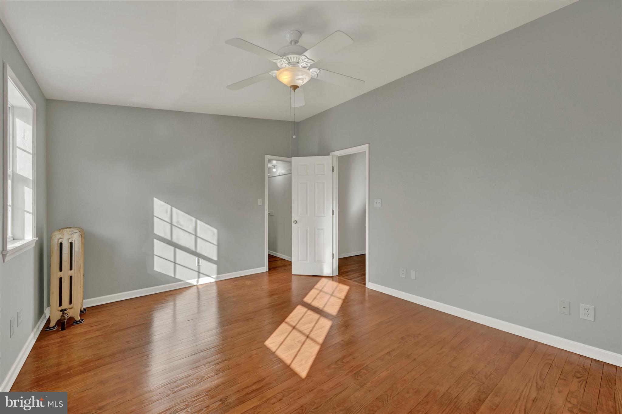 1203 Fairfield Avenue Baltimore, MD 21209 - Photo 21 of 32 a view of an empty room with window and wooden floor