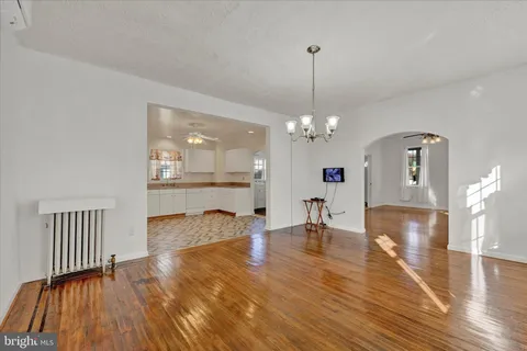 a view of a livingroom with dining room and wooden floor