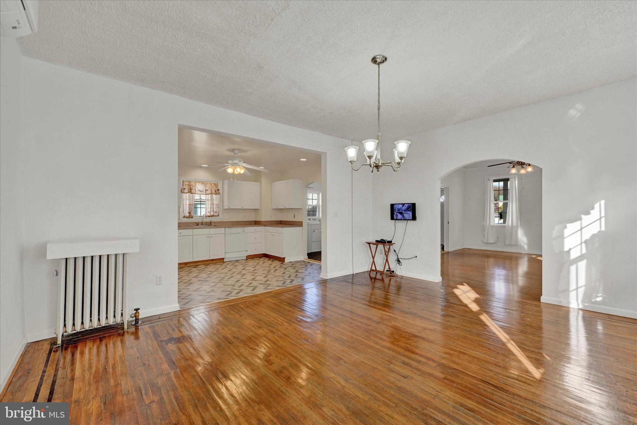 1203 Fairfield Avenue Baltimore, MD 21209 - Photo 8 of 32 a view of a livingroom with dining room and wooden floor