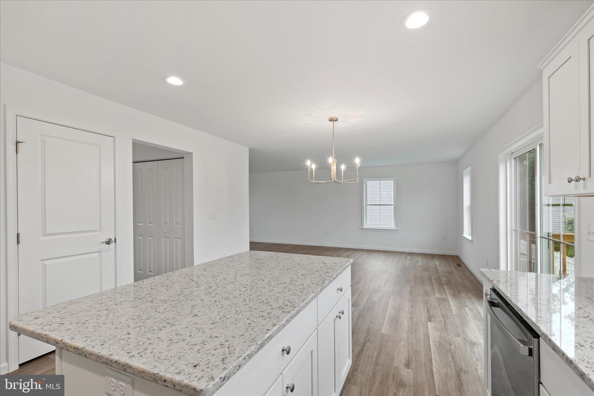 10 Stream Drive Carlisle, PA 17013 - Photo 12 of 48 an empty room with kitchen view and wooden floor