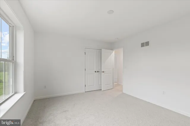 a view of an empty room and a window