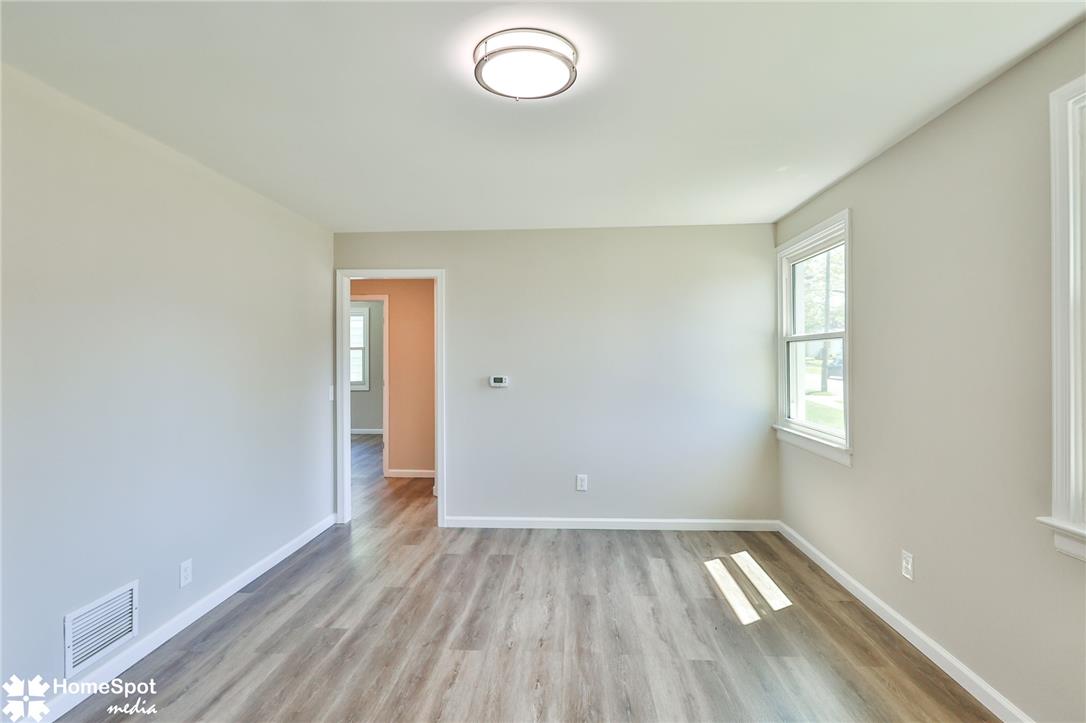 415 Willow Road Hellertown, PA 18055 - Photo 10 of 25 Laminate flooring extends through this room, illuminated by natural light from a window and an overhead flush mount light.
