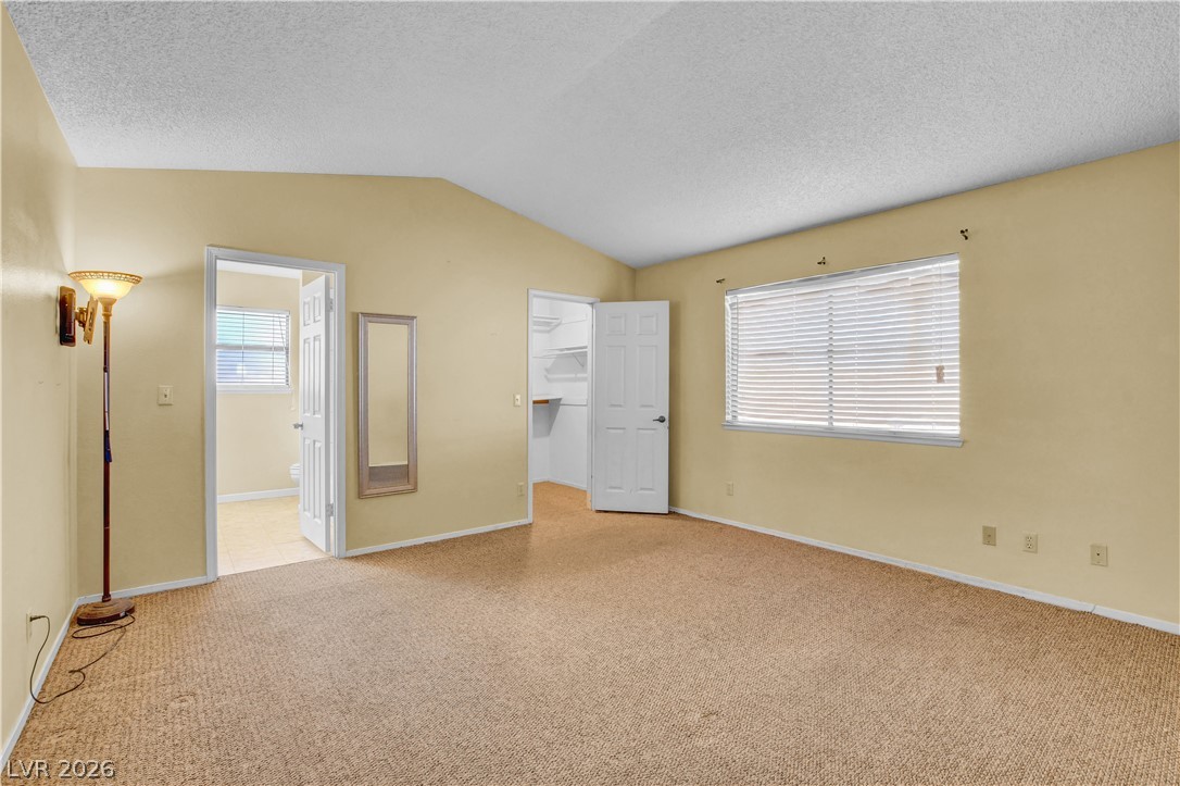 6440 Hartwood Road Las Vegas, NV 89108 - Photo 27 of 59 A spacious bedroom features plush carpet flooring and a convenient walk-in closet.