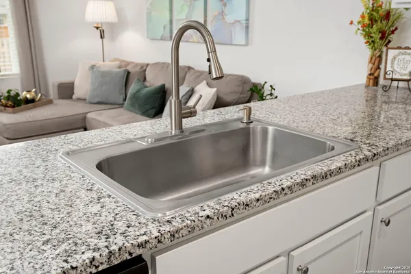 a stove top oven sitting inside of a kitchen