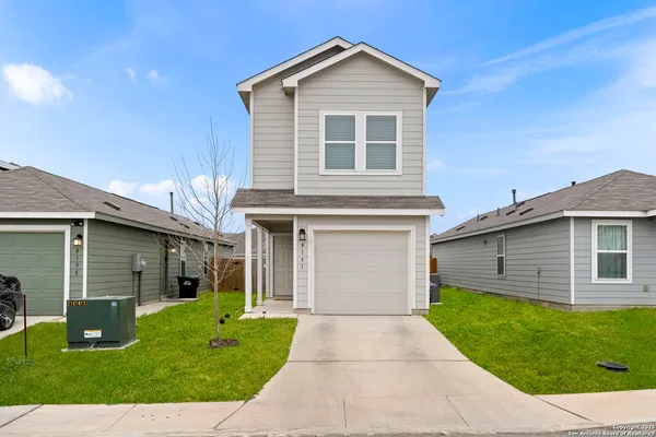 a front view of a house with a yard