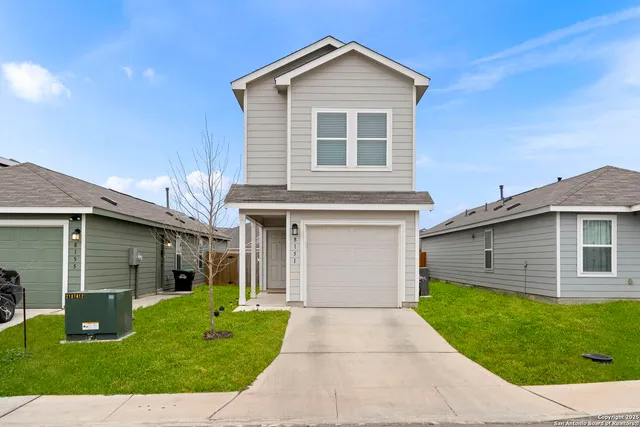 a front view of a house with a yard