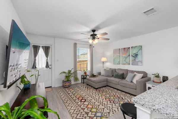 a living room with furniture and a chandelier