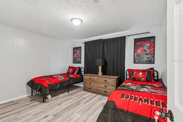 a bedroom with two beds and a closet