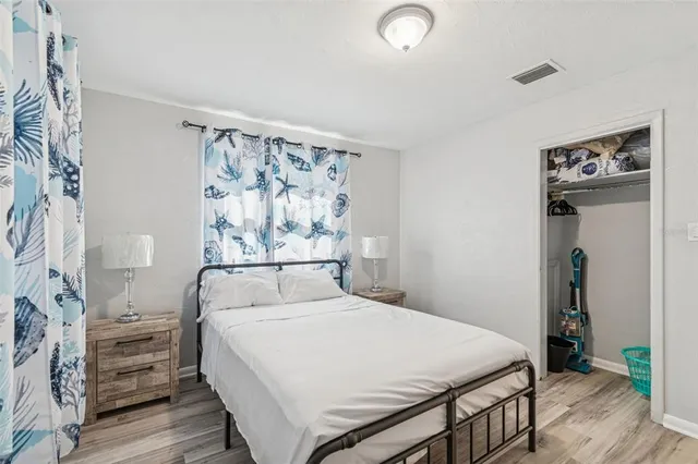 a bedroom with furniture and a wooden floor