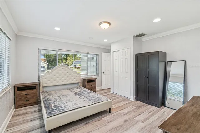 a living room with a bed furniture and next to a window