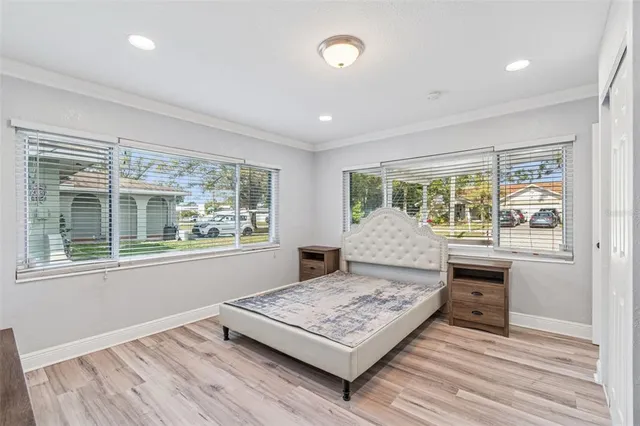 a kitchen with stainless steel appliances granite countertop a refrigerator a stove and a sink with wooden floor